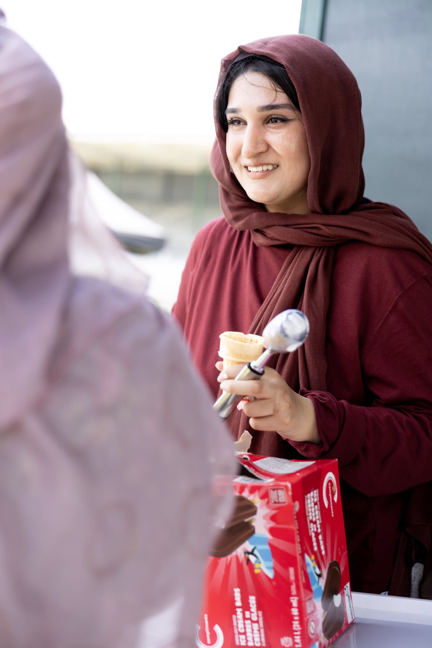 Zainab serving ice cream at the campaign tent on Canada Day