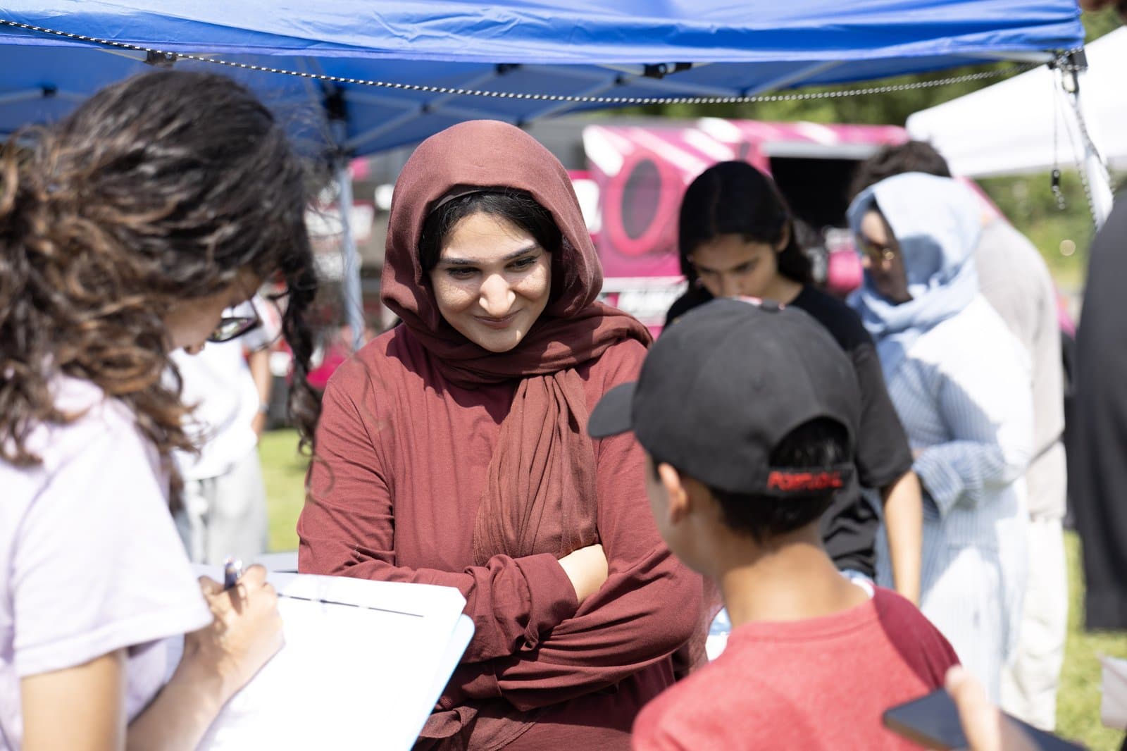 Residents signing up at Zainab's Meet Milton tent