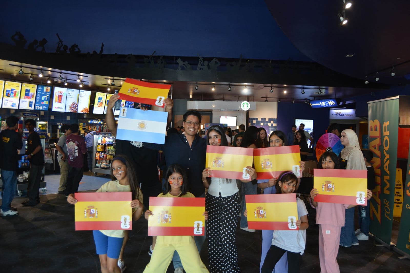Kids holding Spain and Argentina flags in the lobby