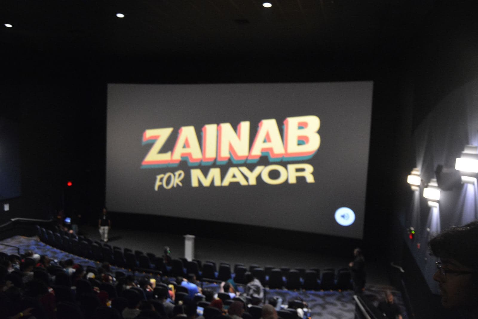 ZAINAB FOR MAYOR on the Cineplex big screen in front of a full theatre