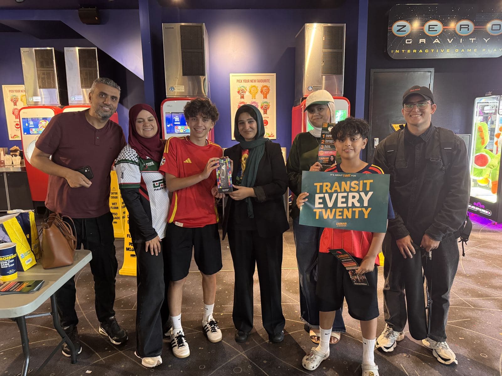 Zainab with young supporters holding a Transit Every Twenty sign